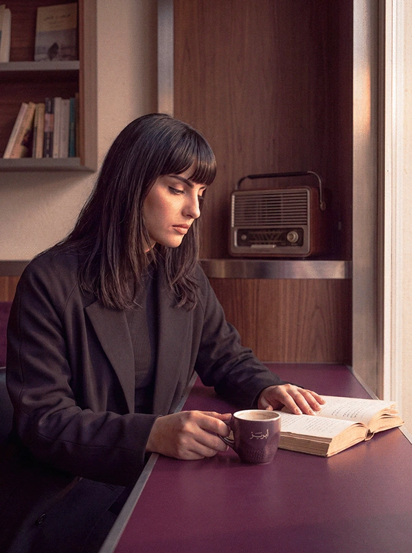 ABREEZ reading at a plum table
